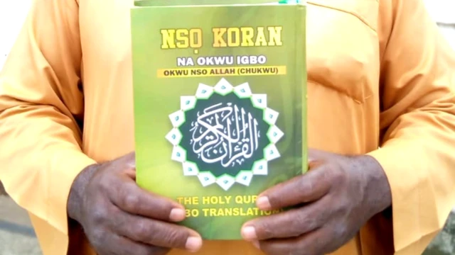 Muhammad Murtala Chukwuemeka holding the Igbo translation of the Quran