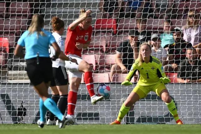 Katharina Schiechtl (C) scores the opening goal past Northern Ireland's goalkeeper Jacqueline Burns