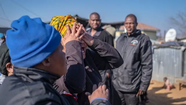 Relatives of victims mourn outside the tavern