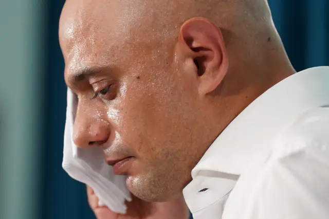 Sajid Javid MP wipes sweat from his face