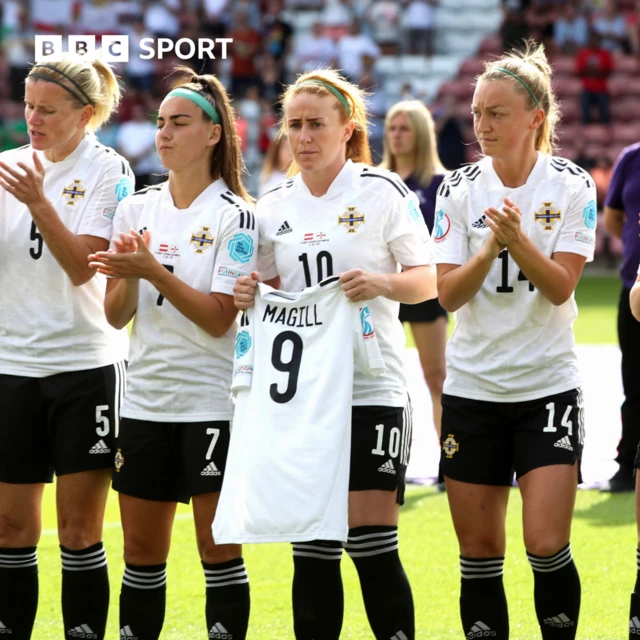 Rachel Furness holds injured team-mate Simone Magill's shirt in the line-up