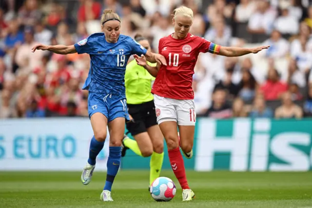 Essi Sainio vies with Denmark's striker Pernille Harder