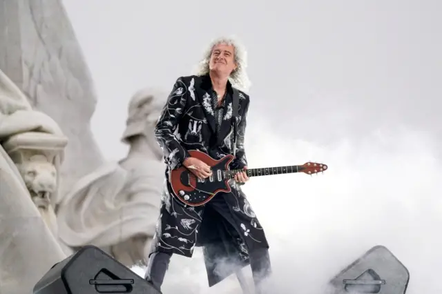 Brian May, astrophysicist and Queen guitarist, plays guitar