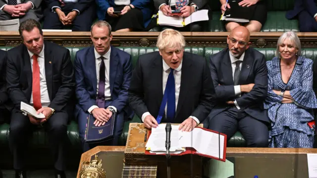 Boris Johnson stands at the despatch box at PMQs