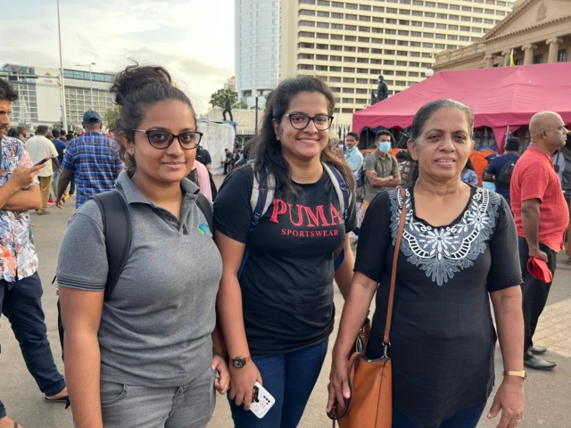 Twin sisters Reshini and Reshani Samarakoon and their mother at protest site Galle Face Green in Colombo