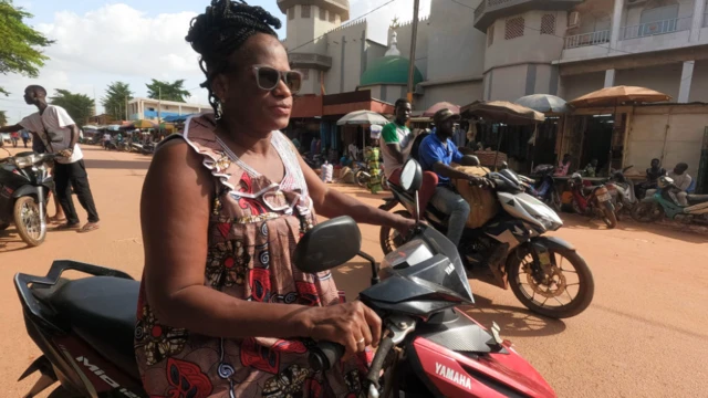 A woman on a motorbike in Ouagadougou, Burkina Faso - Tuesday 12 July 2022