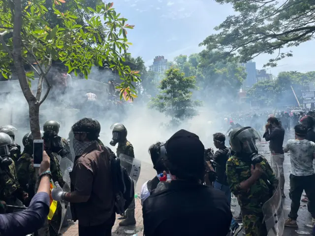 Protesters resist volleys of tear gas to break through the security cordon