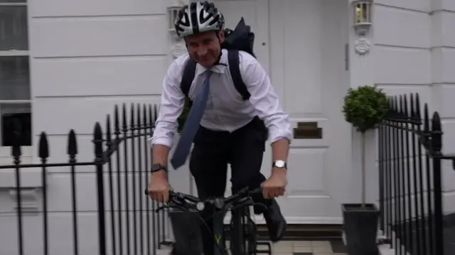 Jeremy Hunt rides a bicycle