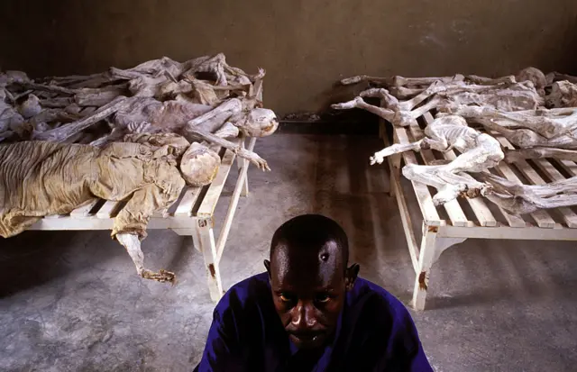 Emanuel Murangira, a genocide survivor, sits at the Murambi memorial site February 14, 2003 in Murambi outside Gikongoro, Rwanda. Mr. Emanuel lost his wife and children and was shot in the head but survived. He is now the caretaker of the site.