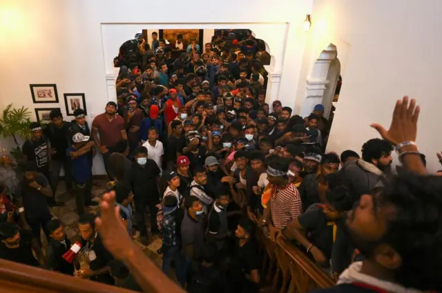 Demonstrators gather inside the office building of Sri Lanka's prime minister