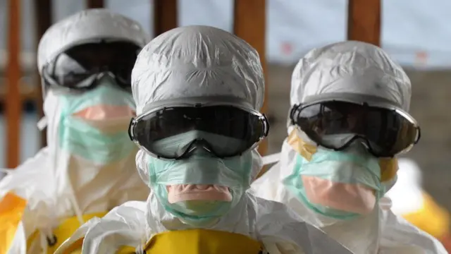 Three people wearing PPE