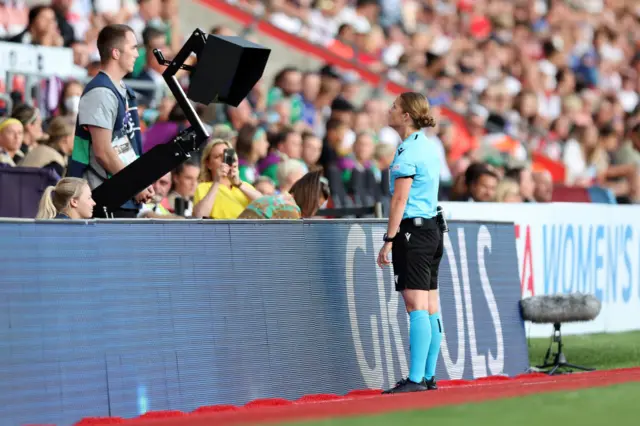 Referee Esther Staubli checks the VAR screen which does not give England a penalty