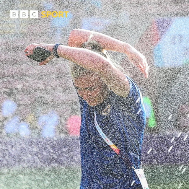 Northern Ireland goalkeeper Jackie Burns gets caught when the sprinklers come on at the stadium