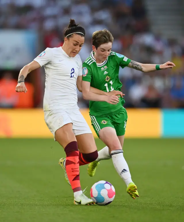 Lucy Bronze of England battles for possession with Kirsty McGuiness of Northern Ireland