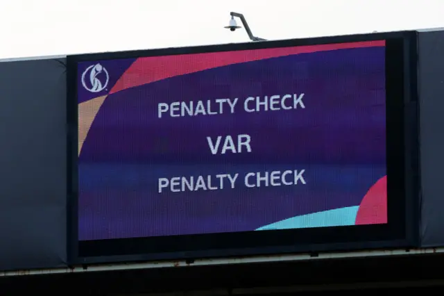 The LED board shows the VAR check for a penalty to England which is not given