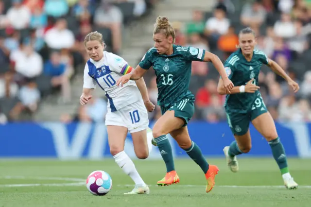 Linda Dallmann of Germany eludes Emmi Alanen of Finland during the UEFA Women's Euro England 2022 group B match between Finland and Germany at Stadium mk