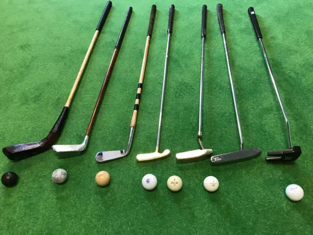 A selection of putters and balls through the years