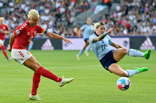 Pernille Harder is challenged by Spain's defender Maria Leon