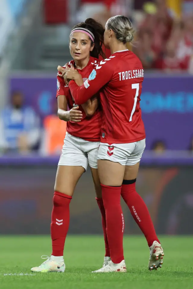 Nadia Nadim of Denmark is embraced by Sanne Troelsgaard during the UEFA Women's Euro 2022 group B match between Denmark and Spain at Brentford Community Stadium