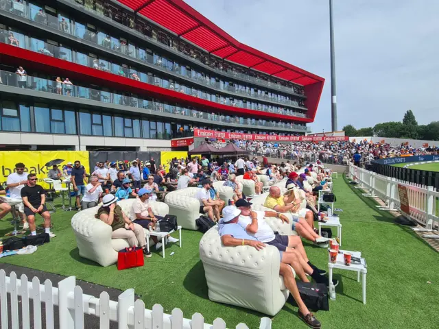 Fans at Old Trafford watch the game from sofas