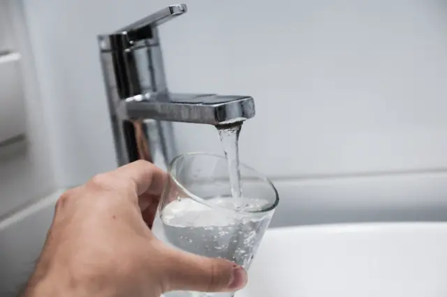 Glass being filled with water