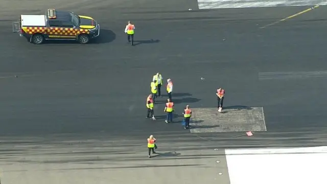 Workers on the runway at Luton airport