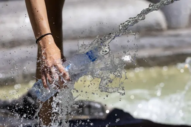 A water bottle being filled