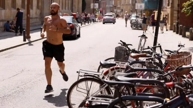 Man running topless in Cambridge