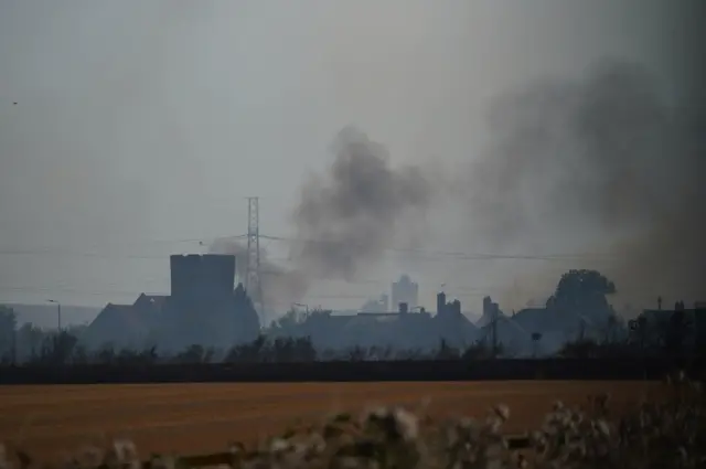 Smoke rises above the village of Wennington