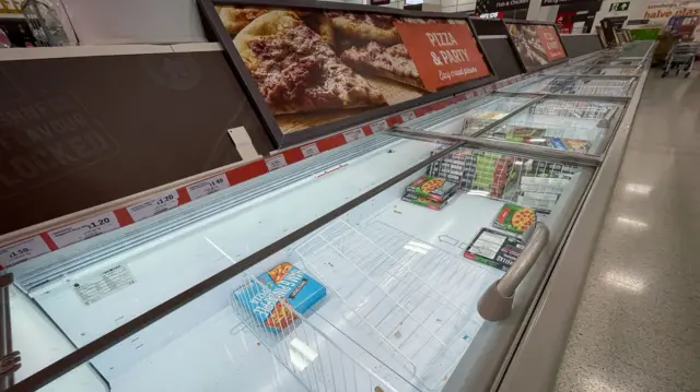 An almost empty freezer section of a Sainsbury's store in Nine Elms, London