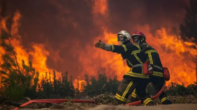 Firefighters battling a forest fire in Landiras, France, 18 July 2022. The Gironde area of France is in the grip of two wildfires.