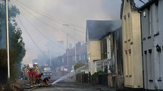 Firefighters at the scene of a blaze in the village of Wennington