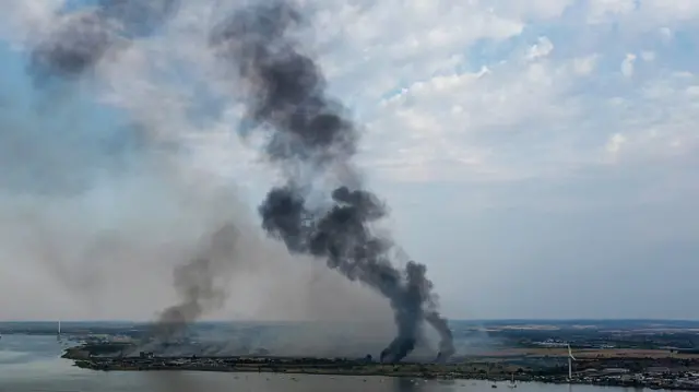 Smoke columns rise from Dartford, Kent