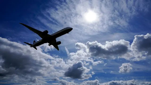 A plane lands on the southern runway at London Heathrow Airport