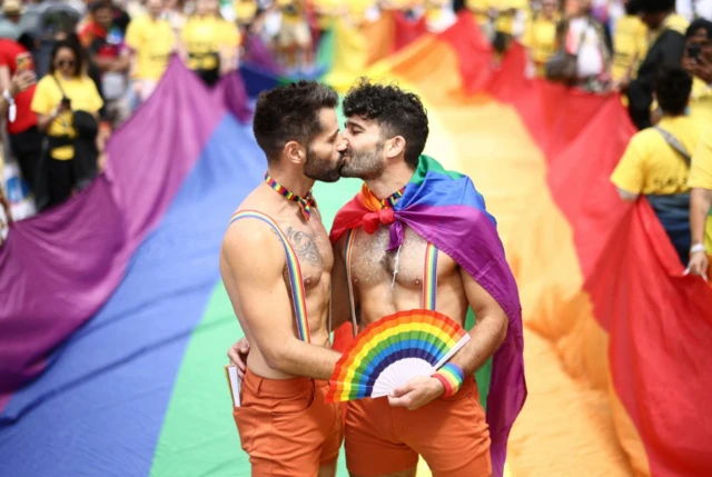 People kiss while taking part in the 2022 Pride Parade in London