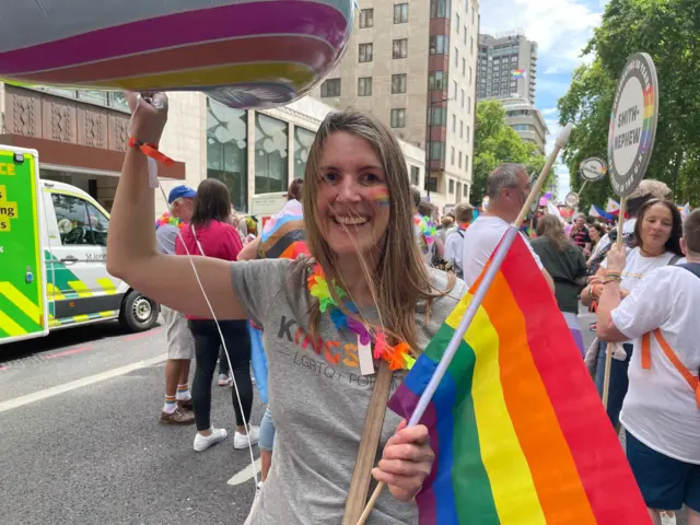 Helene from Surbiton holding an LGBTQ+ flag