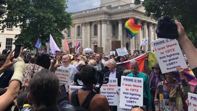 A crowd of people attending a Pride parade