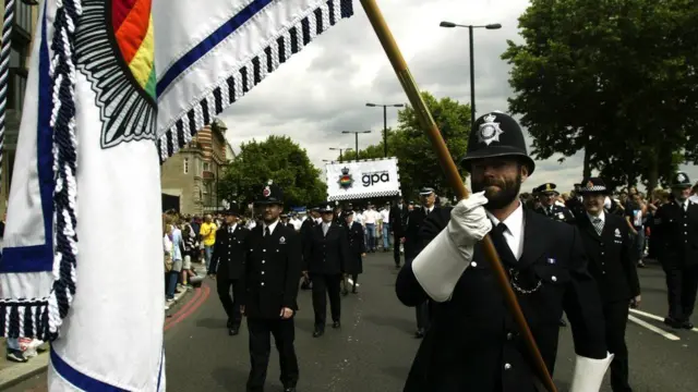 Police officers marching in uniform at Pride in 2003