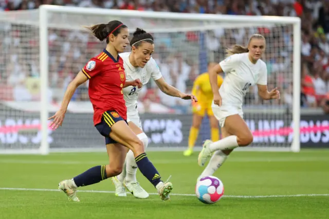 Aitana Bonmati of Spain is challenged by Lucy Bronze of England during the UEFA Women's Euro 2022 Quarter Final match between England and Spain at Brighton & Hove Community Stadium