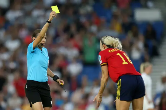Maria Leon of Spain is shown a yellow card by referee Stephanie Frappart during the UEFA Women's Euro 2022 Quarter Final match between England and Spain at Brighton & Hove Community Stadium