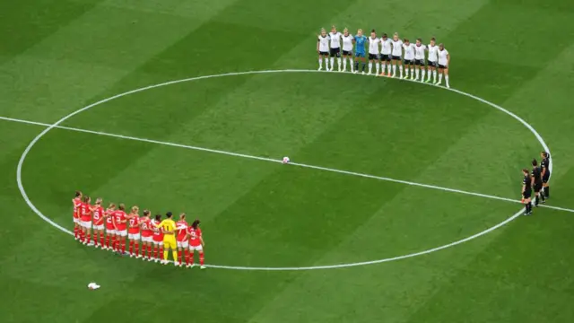 Players hold a minute's silence