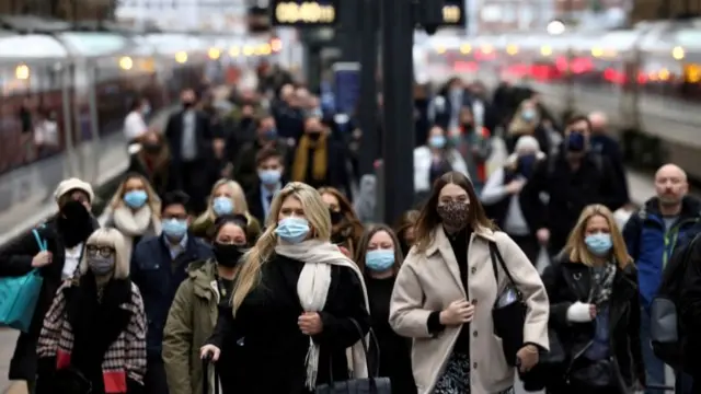 Commuters arrive at King's Cross in London, December 2021