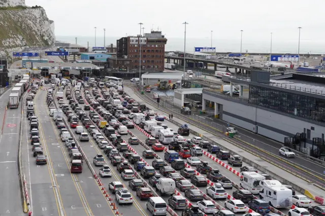 Cars queue at the check-in at the Port of Dover in Kent as many families embark on getaways at the start of summer holidays for many schools in England and Wales