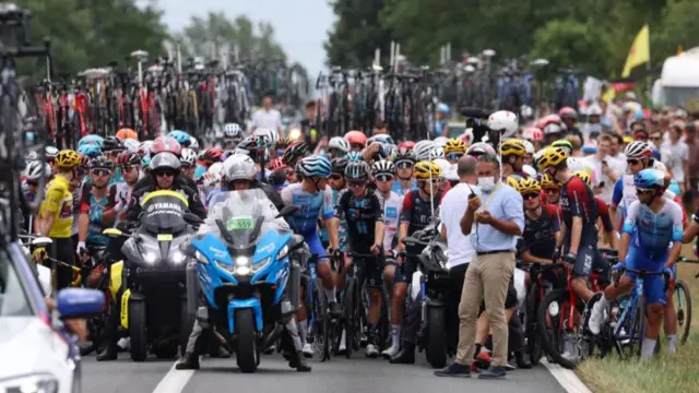 The peloton is stopped because of a protest