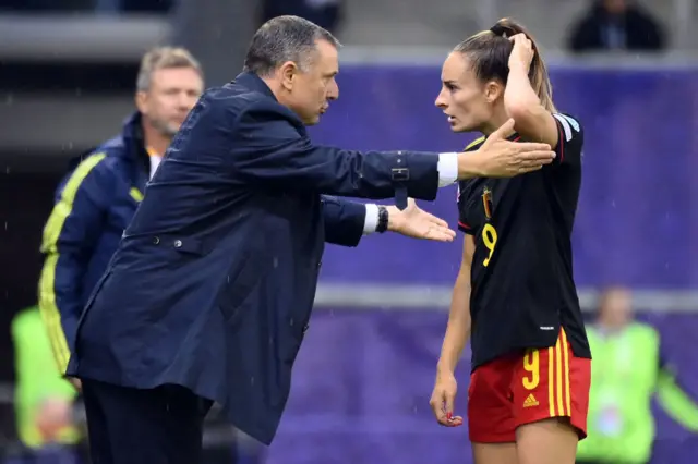 Belgium's head coach Yves Serneels (L) talks with Belgium's striker Tessa Wullaert during the UEFA Women's Euro 2022 quarter final football match between Sweden and Belgium at the Leigh Sports Village Stadium, in Leigh, on July 22, 2022