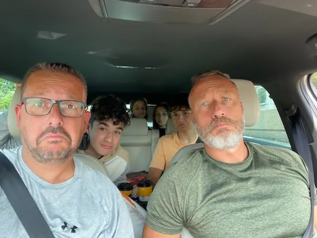 A family stranded in a car outside the Port of Dover pull sad faces