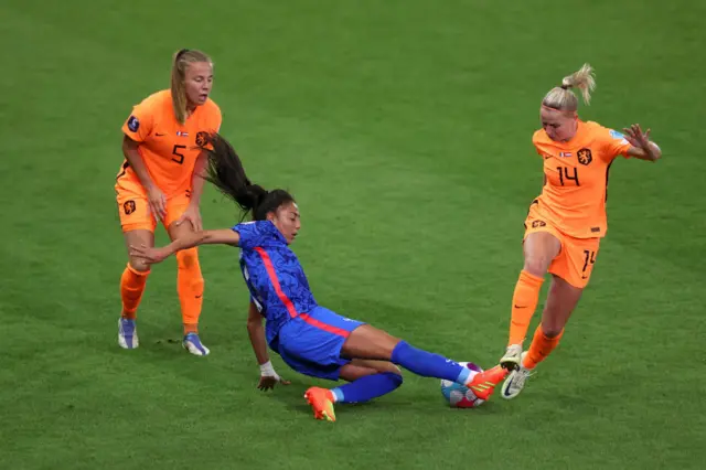 Selma Bacha of France is challenged by Lynn Wilms and Jackie Groenen of The Netherlands during the UEFA Women's Euro 2022 Quarter Final match between France and Netherlands at The New York Stadium on July 23, 2022 in Rotherham, England.