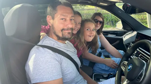 Dave Harvey and his family in their car