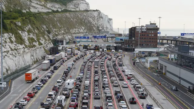 Families queue as they embark on getaways following the start of summer holidays