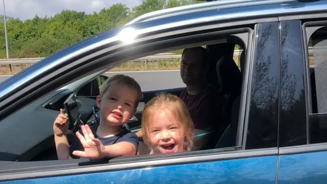 Emma's family waiting in the car